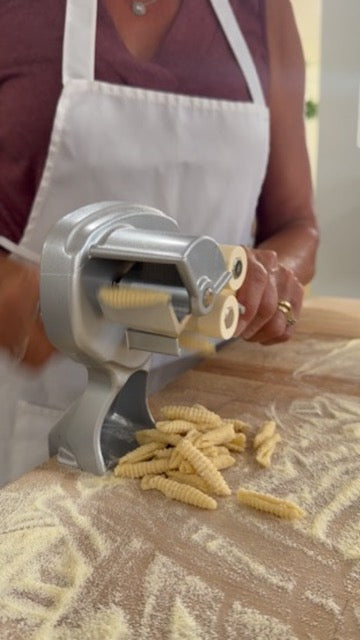 Fresh pasta dough being rolled and cut by hand