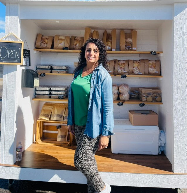 featured is founder of eat well in front of local bread cart