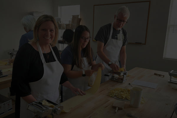 Students shaping handmade pasta during a sourdough pasta class at Eat Well ABQ