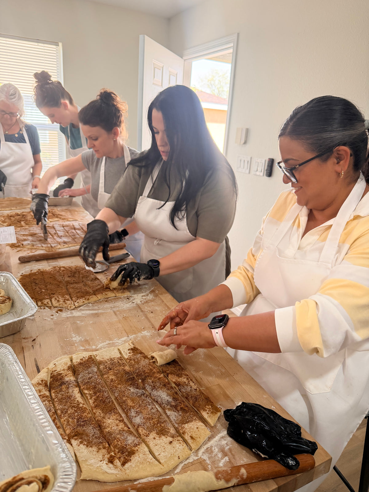 Hands-on sourdough bread class with students shaping artisan dough at Eat Well ABQ